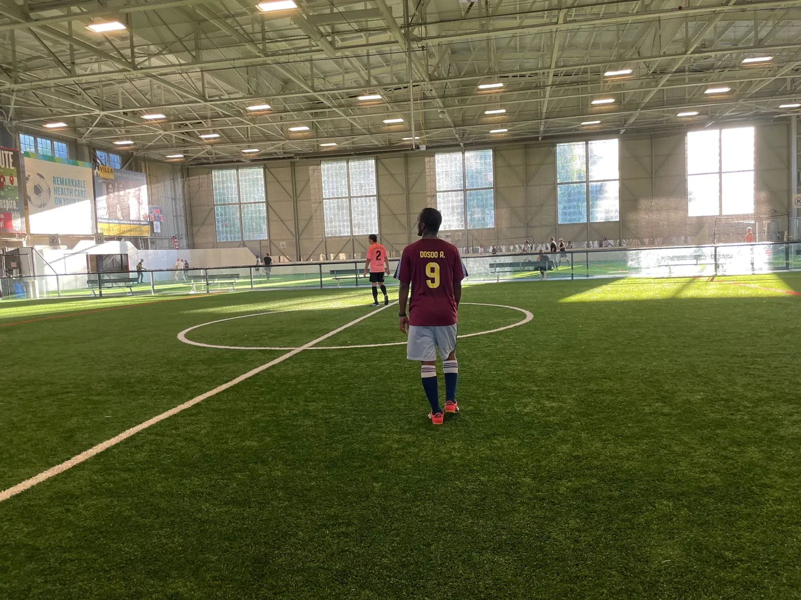 Me from behind on an indoor soccer field, wearing my maroon number 9 jersey